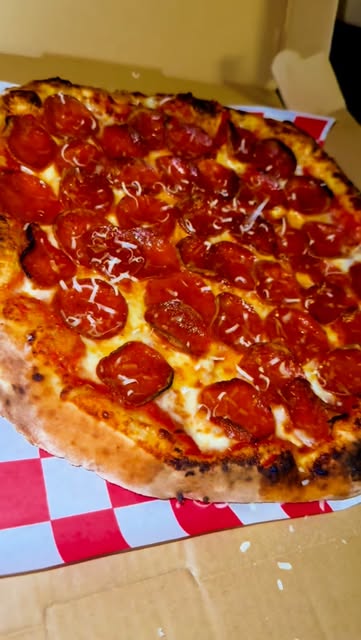 Giani’s pepperoni pizza with a golden wood-fired crust